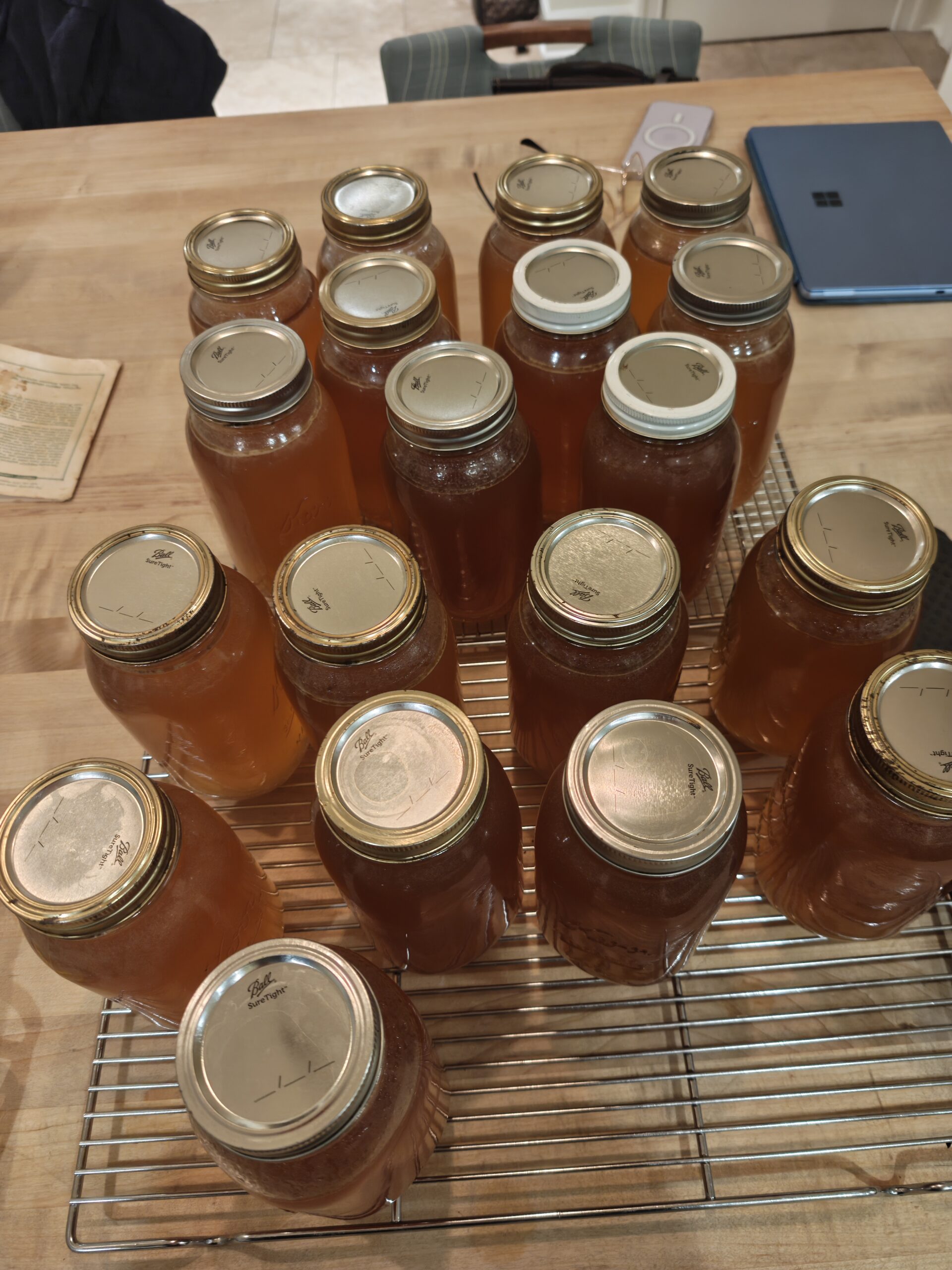 17 quarts of chicken stock on a table